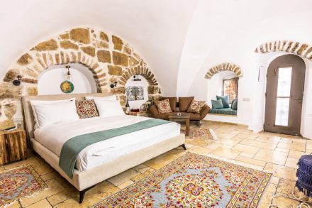 Suite 10. Boutique suite with a king-size bed, colorful rugs, and authentic design at Flora Valley Boutique Hotel, Ein Kerem, Jerusalem