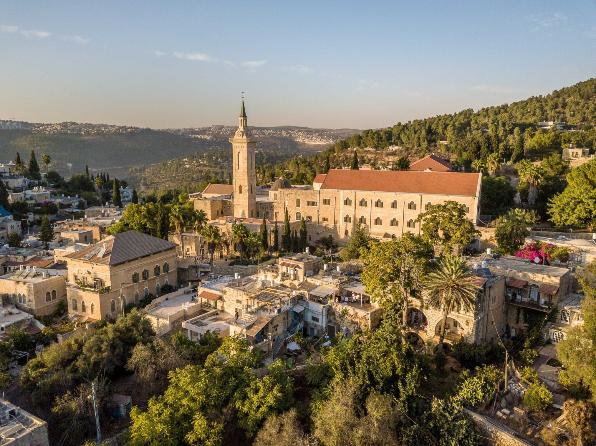 Aerial view of Ein Kerem, Jerusalem – a picturesque landscape featuring historic monasteries, lush hills, and the area's signature stone houses, near Flora Valley Boutique Hotel, Ein Karem, Jerusalem.