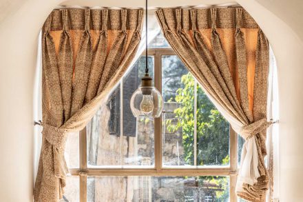 Large window with rustic curtains at Flora Valley Boutique Hotel, Ein Kerem, Jerusalem – natural light and a warm ambiance