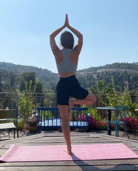 Yoga practice on the rooftop of Flora Valley Boutique Hotel, Ein Kerem, Jerusalem – a serene experience with breathtaking green views