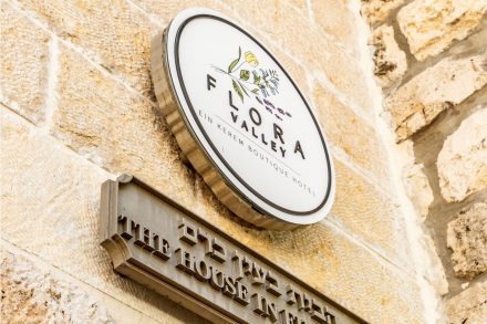 Entrance sign of Flora Valley Boutique Hotel, Ein Kerem, Jerusalem – a luxurious hospitality experience in a historic neighborhood